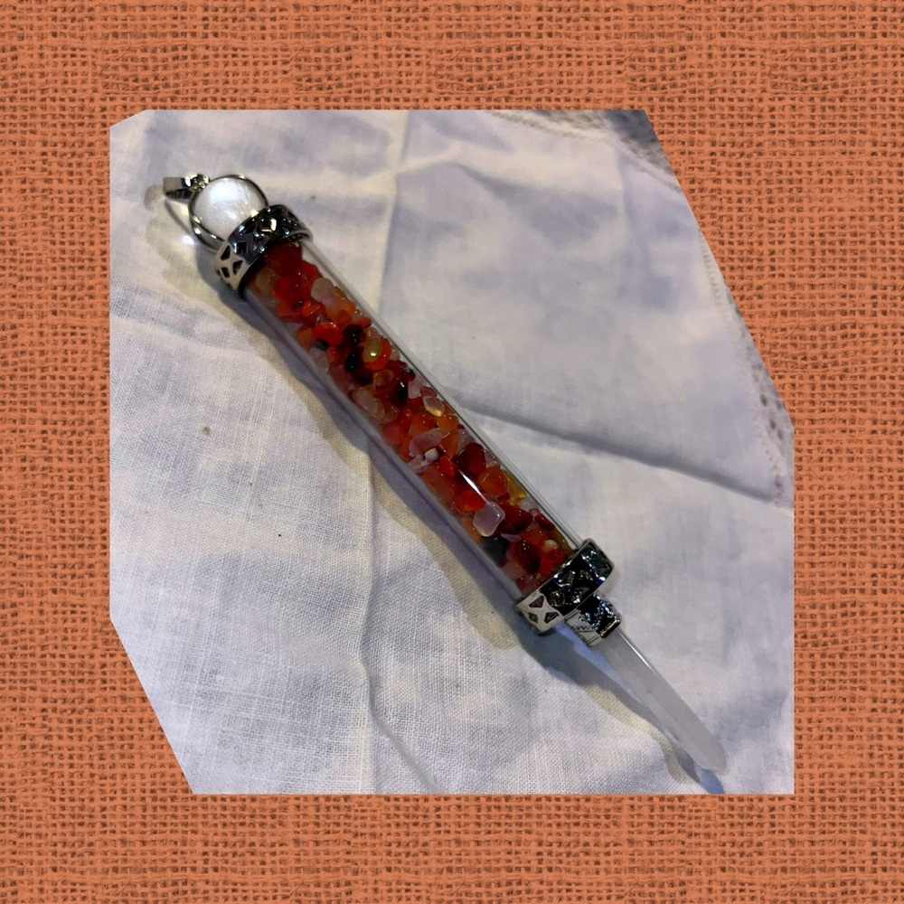 Pendulum with carnelian encased with a crystal point.